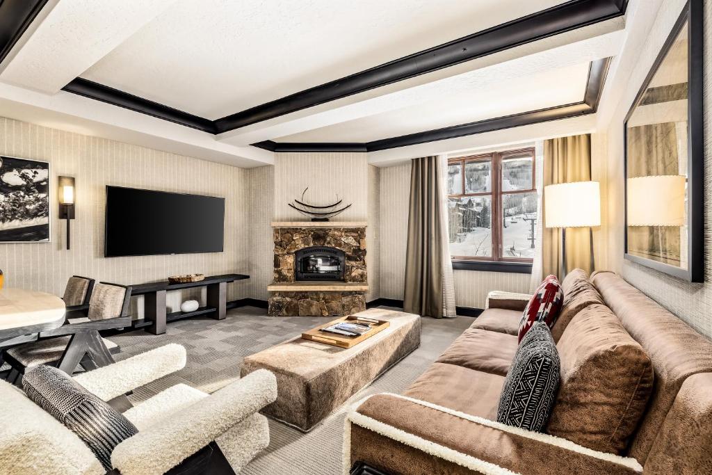 a living room with a couch and a fireplace at Luxe Bachelor Gulch Getaway! in Edwards
