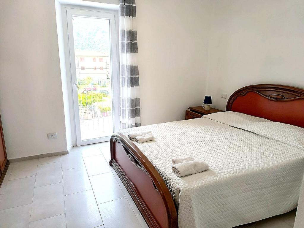 a bedroom with a bed with two towels on it at Paradise Home just a few minutes from Lake Maggiore in Gravellona Toce