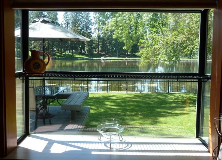 a window view of a patio with a view of a lake at Mirror Pond bungalow in Bend