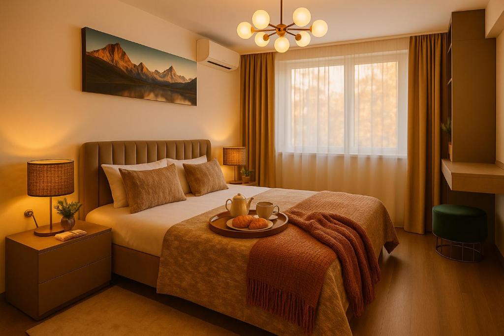 a bedroom with a bed with a tray of fruit on it at OnTop Apartments in Braşov
