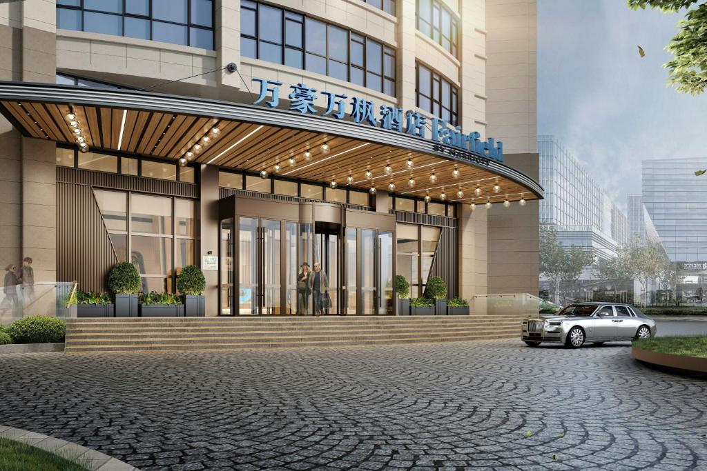 a building with a car parked in front of it at Fairfield by Marriott Qingdao West Coast in Qingdao