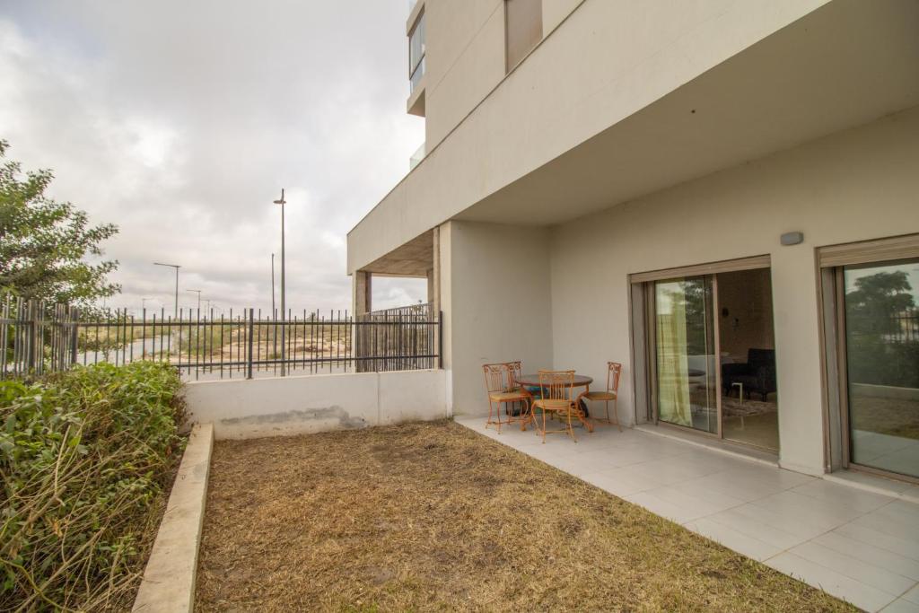 a balcony of a house with a table and chairs at Zenitude in Casablanca