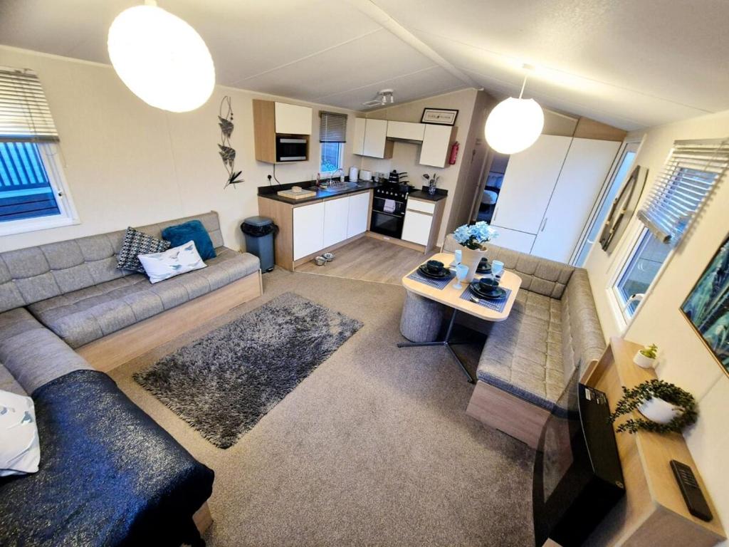 a large living room with a couch and a kitchen at Birchington Vale - Etchingham Sleeps 6 Family Friendly, Pet Friendly in Birchington