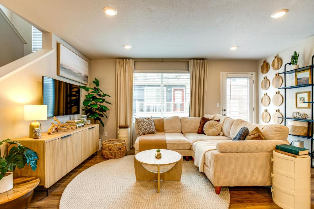 a living room with a couch and a table at 13 Mi to Dtwn Denver Spacious Home with Balcony! in Denver
