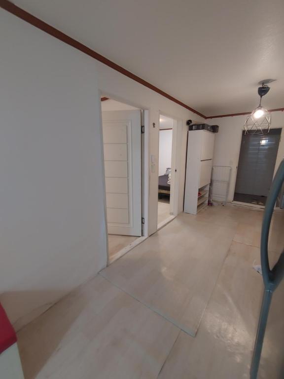 an empty room with a white wall and a door at Sinchon House close to the airport in Seoul