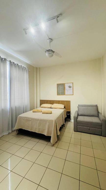 a bedroom with a bed and a chair in it at Studio 714 - Flamengo in Rio de Janeiro