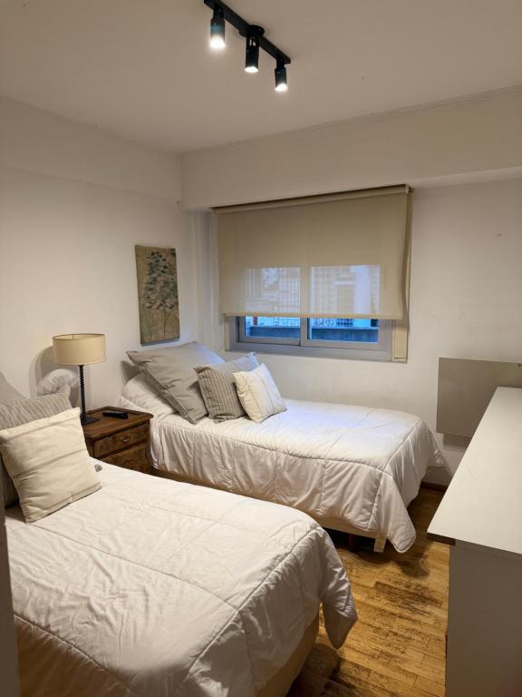 a bedroom with two beds and a window at Centrico in La Plata