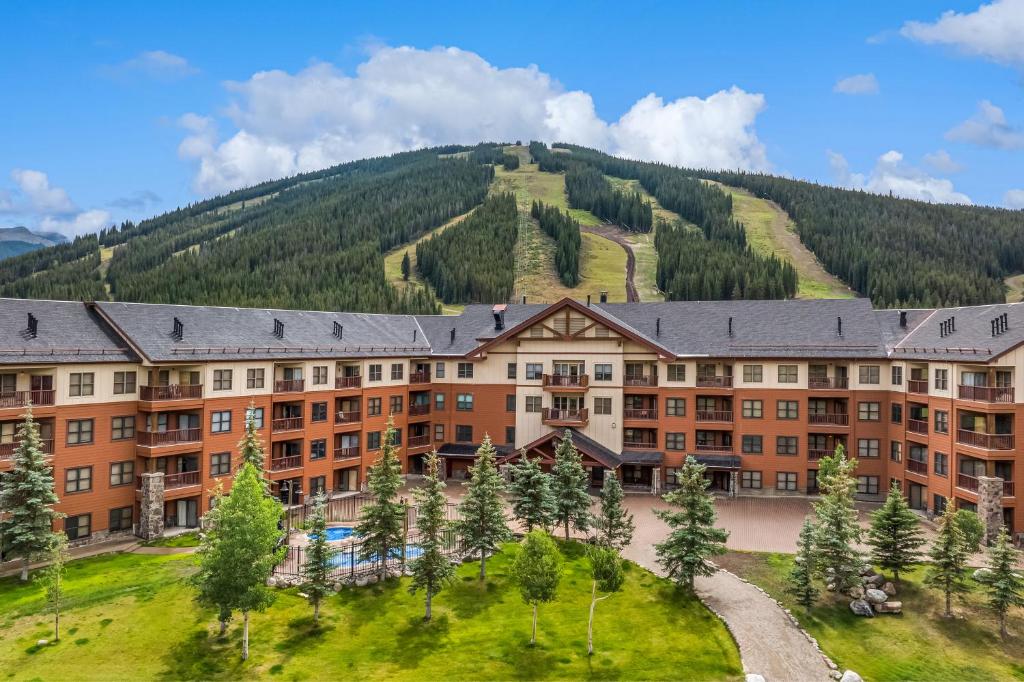 an apartment building with a mountain in the background at Small Town Feel Big Mountain Access in Frisco