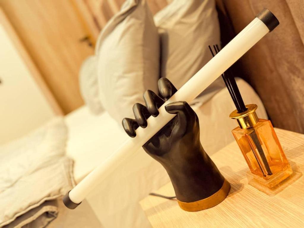 a statue of a hand holding a baseball bat at Oasis in the Heart of Lekki Phase I in Moba