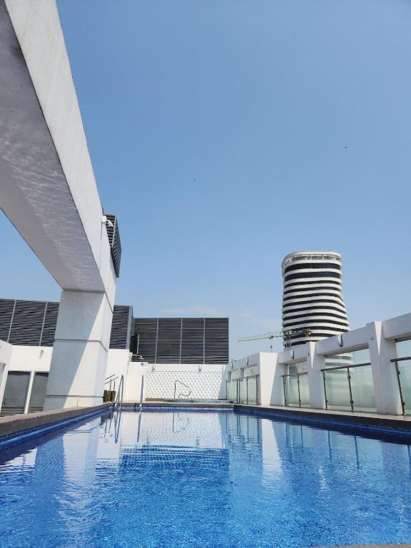 a large swimming pool in front of a building at EcuOlimpo Lighthouse Stay double in Guayaquil