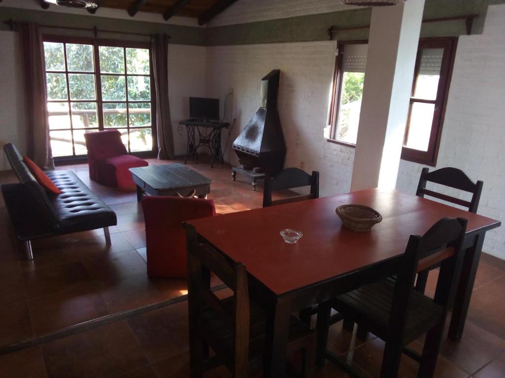 a living room with a table and a piano at PORTOFINO Piriapolis in Piriápolis