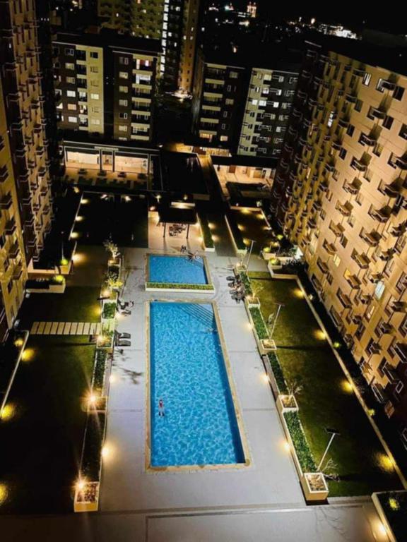 an overhead view of two pools in a building at 720 1 Bedroom Storey 2 Max 6 Pax Condo Central, Cozy in Iloilo City