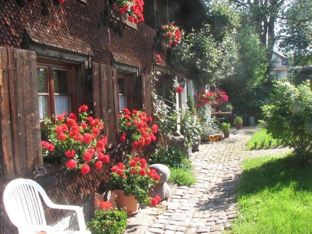 a house with flowers on the side of it at One-bedroom apartment in Friedenweiler-Rotenbach