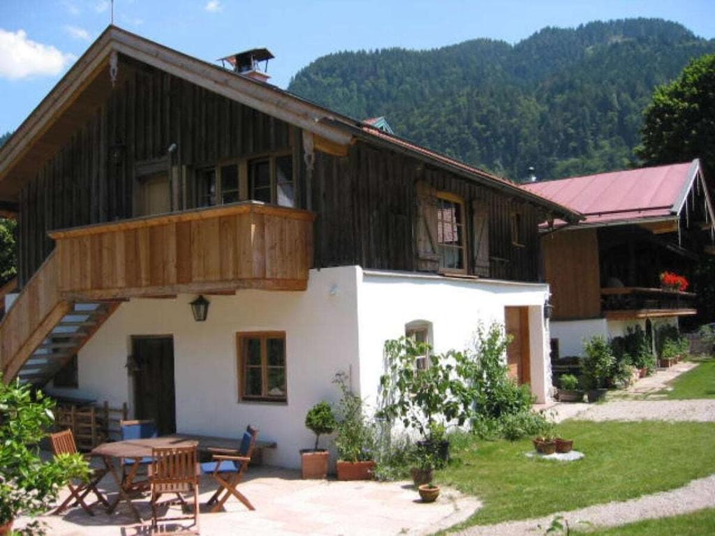 a wooden house with a table in front of it at 1-bedroom holiday home in Sachrang