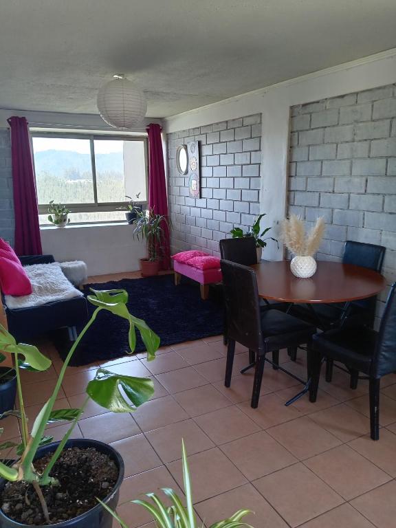 a living room with a table and chairs at Magenta departamentos in Constitución