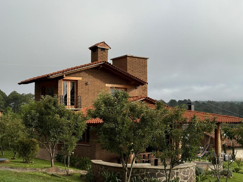 タパルパにあるCabaña Lince Tapalpaの煙突付きのレンガ造りの家