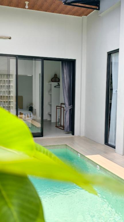 a house with a swimming pool in a room at Sadewa Villa Batu in Punten