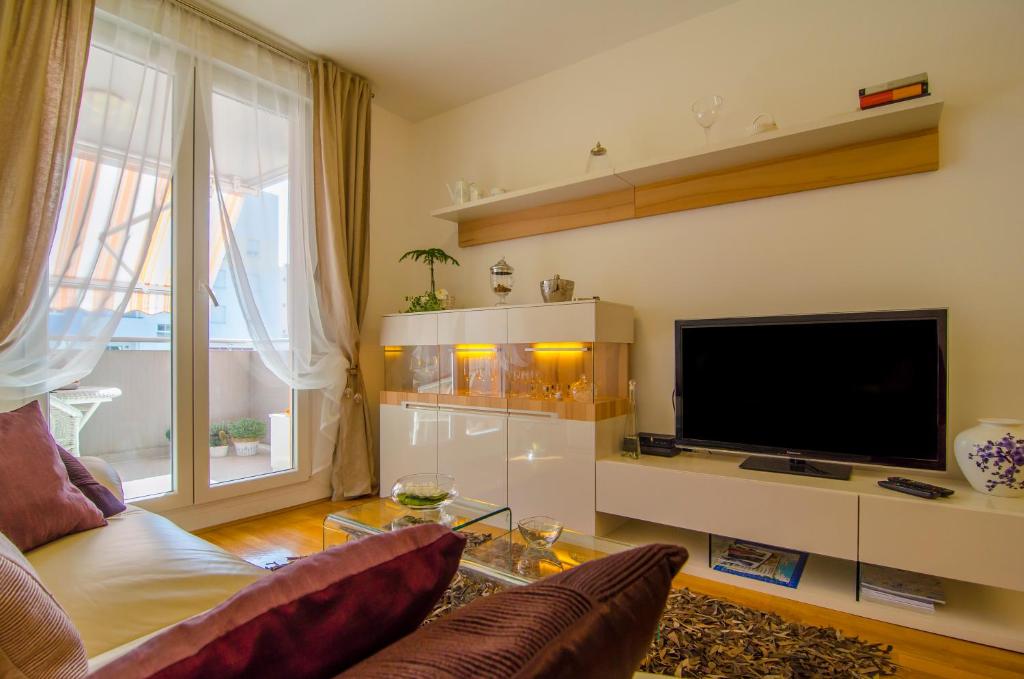 Televízia a/alebo spoločenská miestnosť v ubytovaní Harmony Apartment