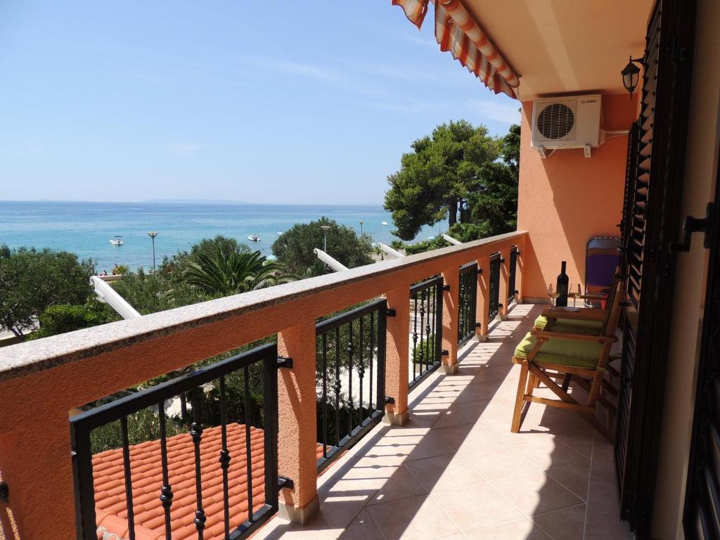 a balcony with a view of the ocean at Apartments Denona in Novalja