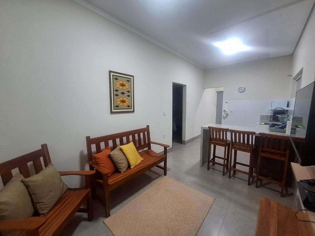 a living room with two benches and a table at Flats de 2 quartos in Regente Feijó
