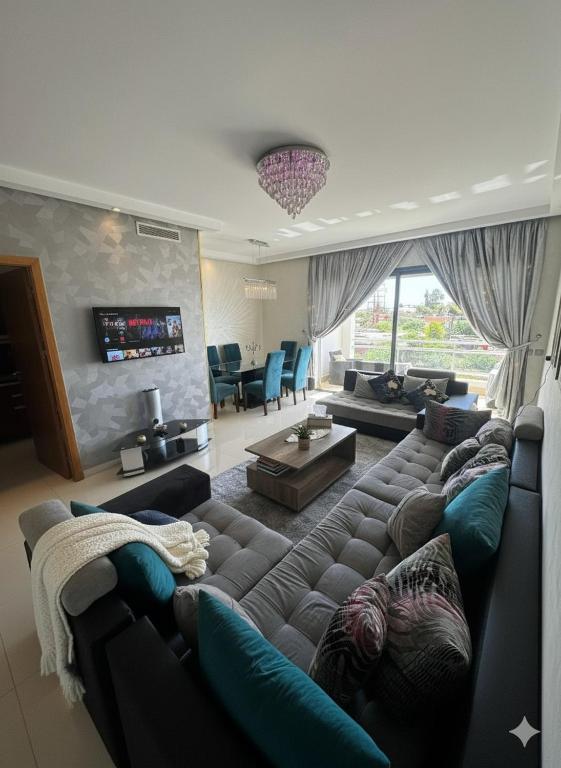 a living room with a couch and a tv at Beachside Charming Apartment in Tamaris