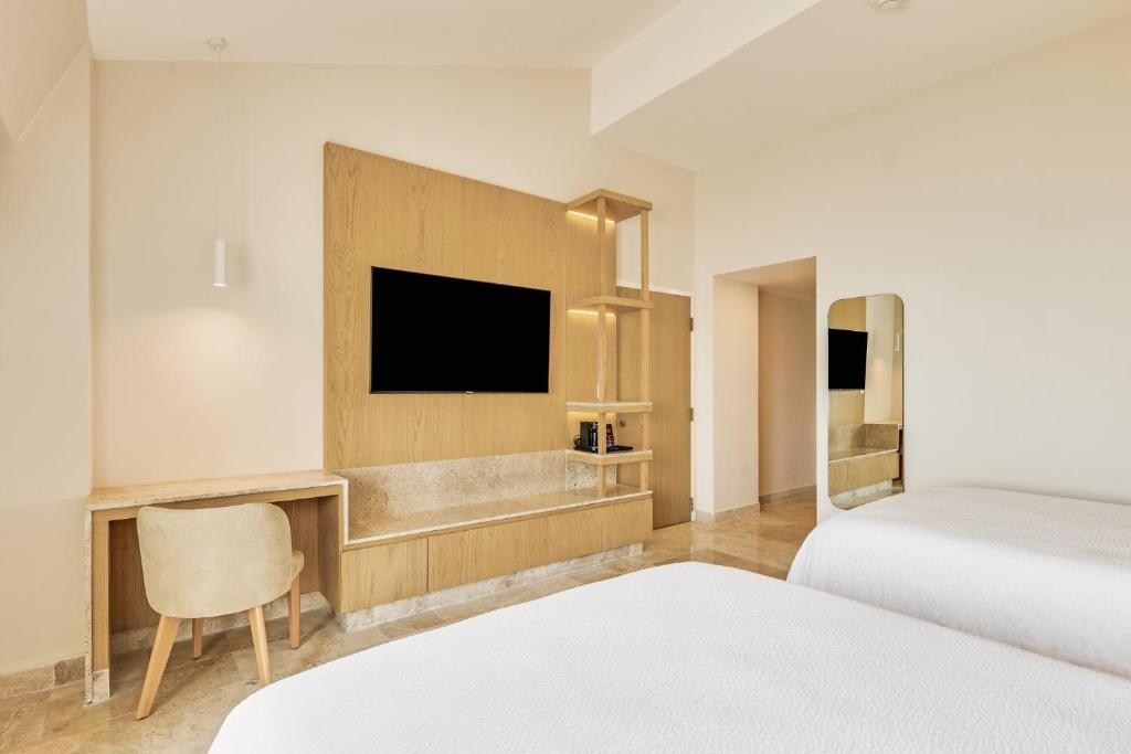 Ένα ή περισσότερα κρεβάτια σε δωμάτιο στο Fiesta Inn Veracruz Boca Del Rio