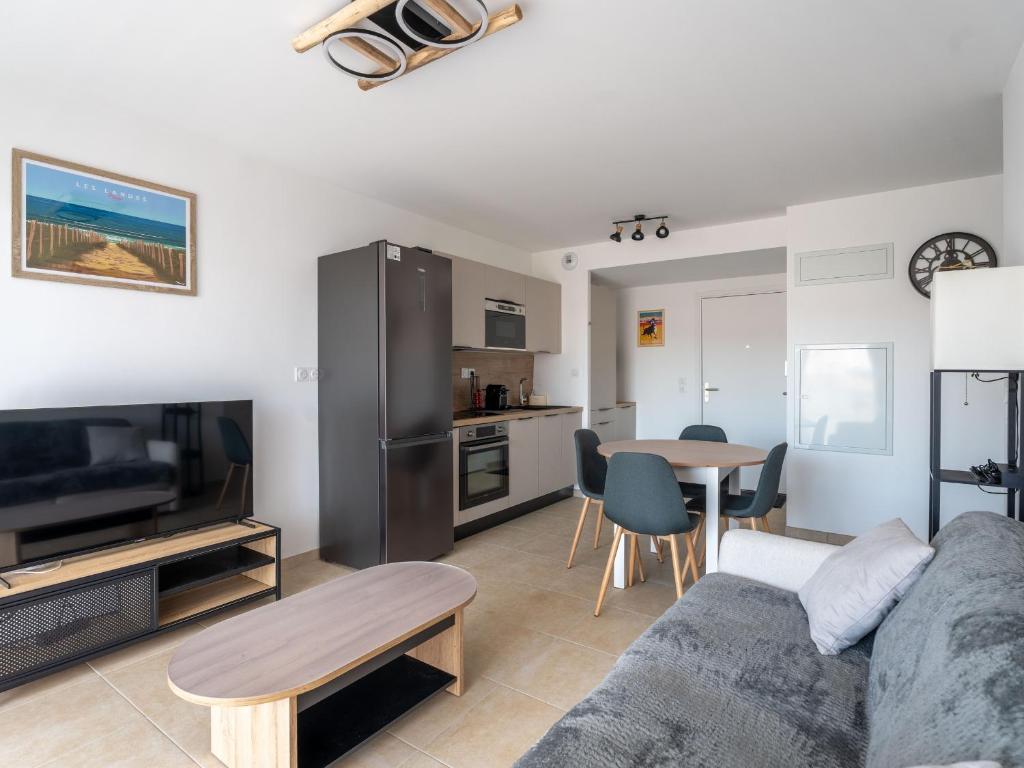 a living room with a couch and a table at Beau T2 Neuf avec Jardinet, Parking et WIFI à Mimizan - FR-1-50-153 in Mimizan