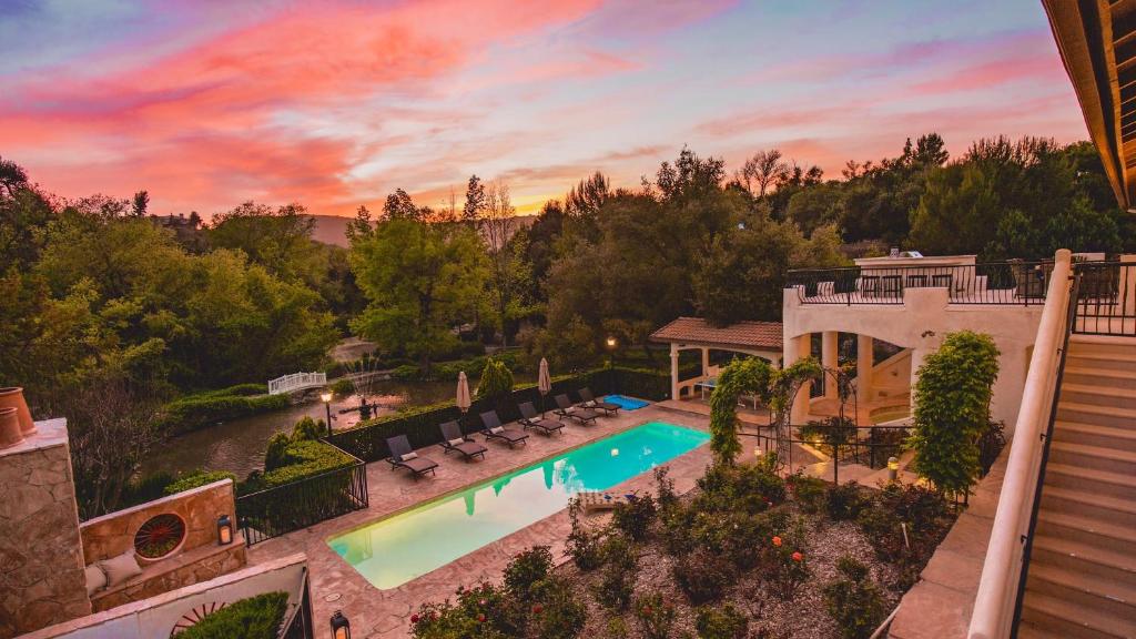 an aerial view of a house with a swimming pool at De Luz by AvantStay 5 Acre Estate w Lake Pool Hot Tub in Murrieta