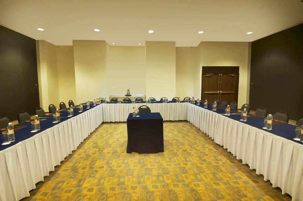 A large meeting room is arranged in a U-shaped conference layout.