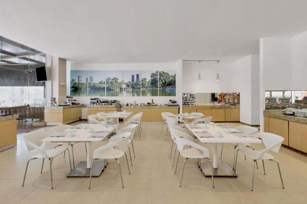 A self-service dining room with neatly set tables and buffet counters.