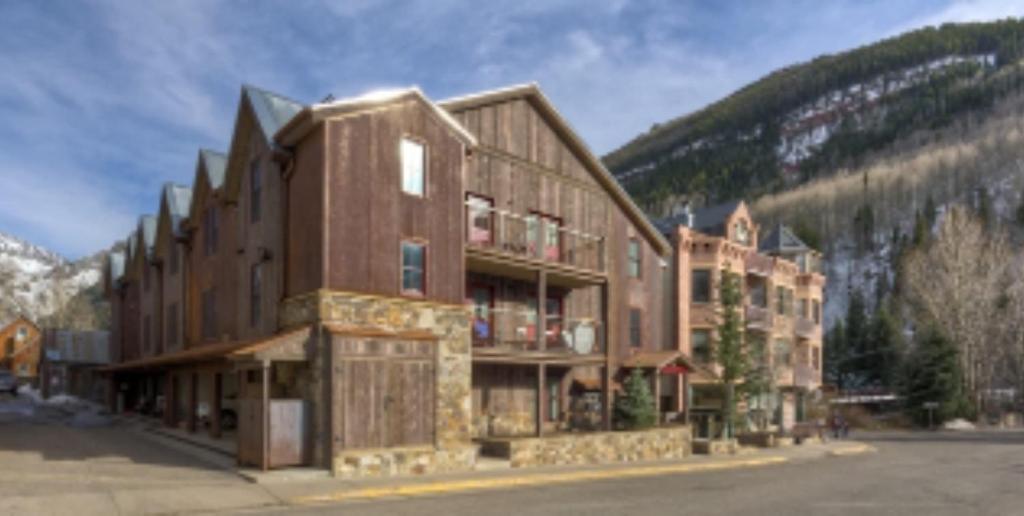 a large building in front of a mountain at Ore Station 2 by AvantStay Modern Oasis in the Heart of Telluride w Hot Tub in Telluride