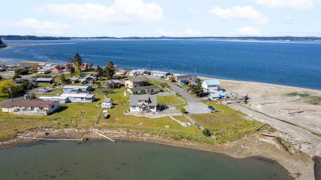 an aerial view of a house on an island in the water at Sunny by the Sound by AvantStay Coastal Escape in Coupeville