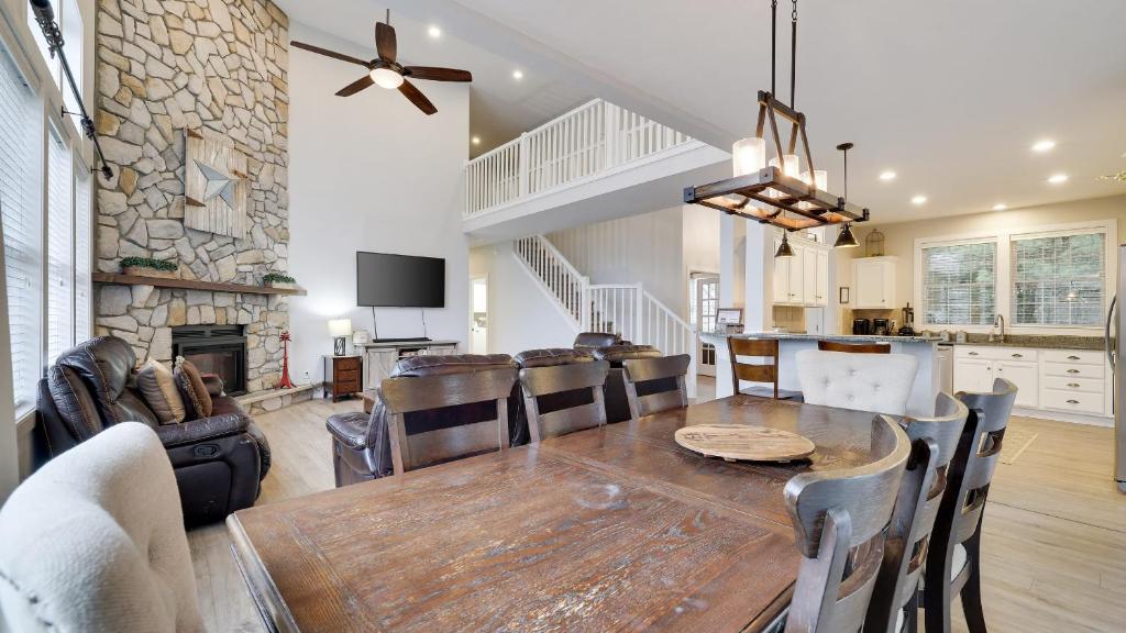 a dining room and living room with a table and chairs at The Nest at Pinecrest by AvantStay Spacious Deck Game Room Fire Pit in Pocono Pines