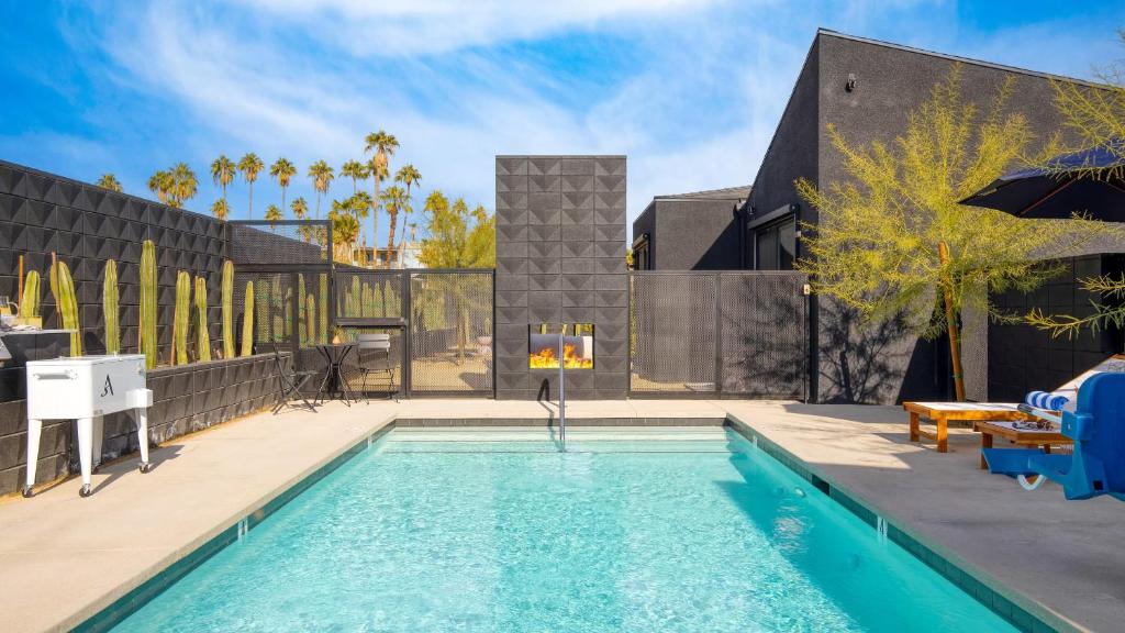 a swimming pool in the backyard of a house at Blackhaus C: 4 Bedroom Suite by AvantStay 4-Room Retreat in Palm Springs