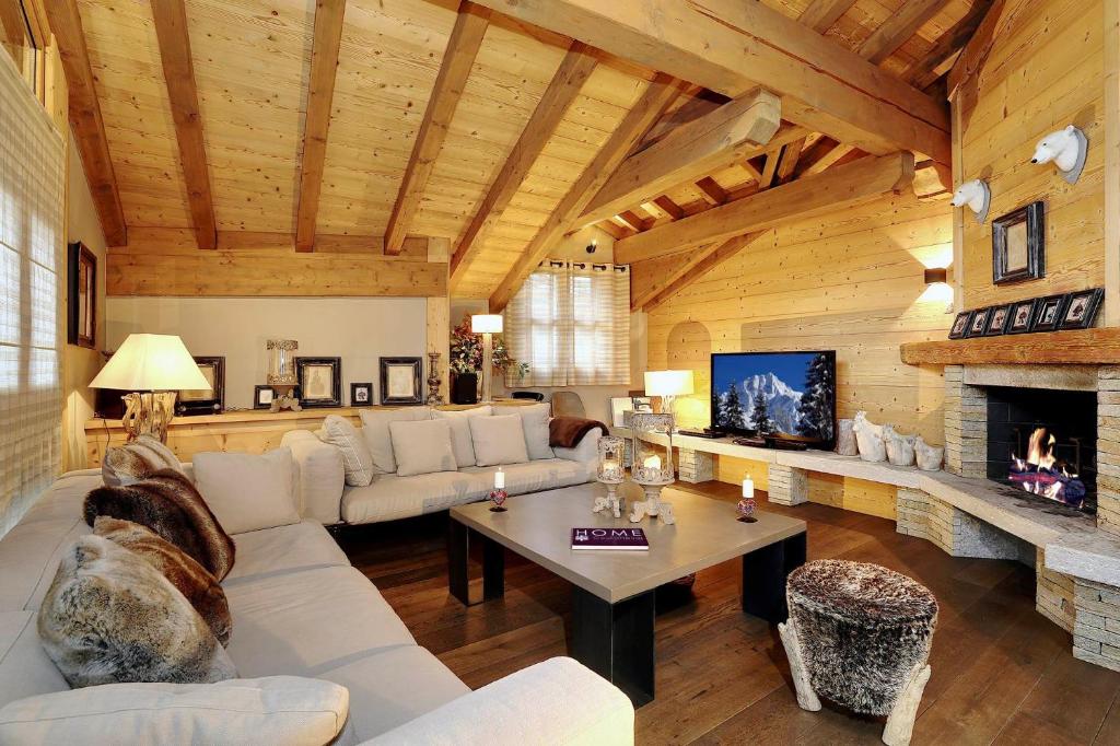 a living room with a couch and a fireplace at Charming village chalet in Saint-Bon-Tarentaise