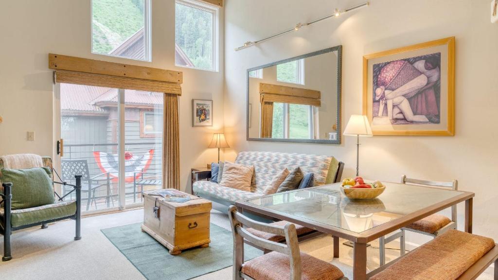 a living room with a table and a couch at Double Diamond 23 by AvantStay Close to Town The Slopes in Telluride