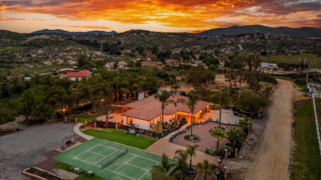 an aerial view of a house with a tennis court at Breathtaking Meadows by AvantStay Temecula Group Retreat Pool Pickleball Firepit Hot Tub in Temecula