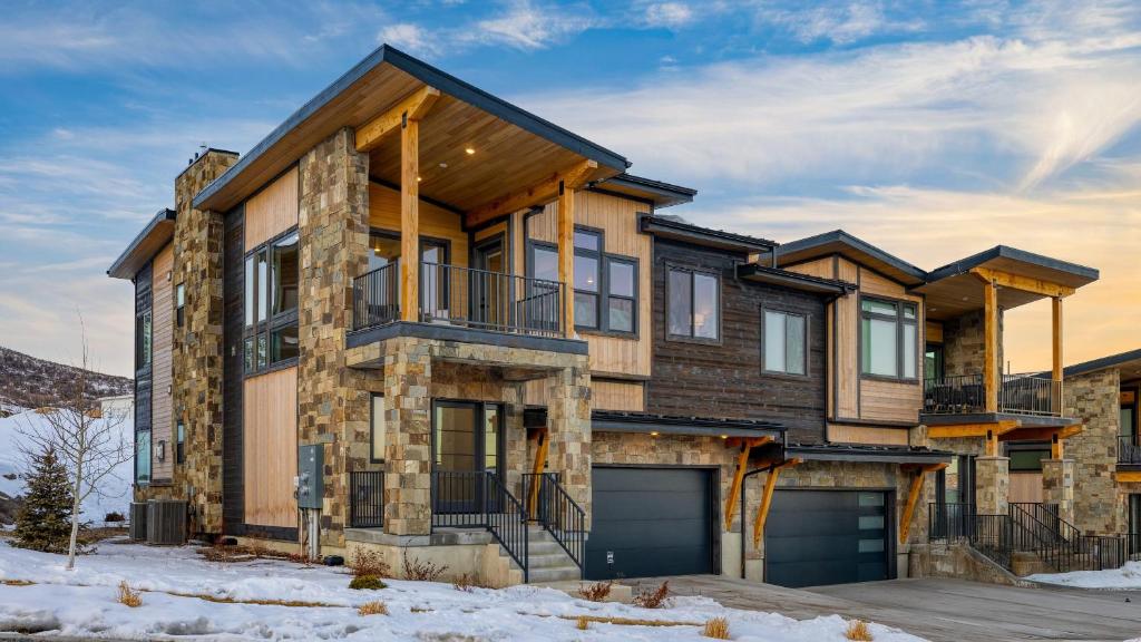 a house with a garage in the snow at Ski La Vie by AvantStay Hot Tub Game Room Near the Ski Slopes in Heber City