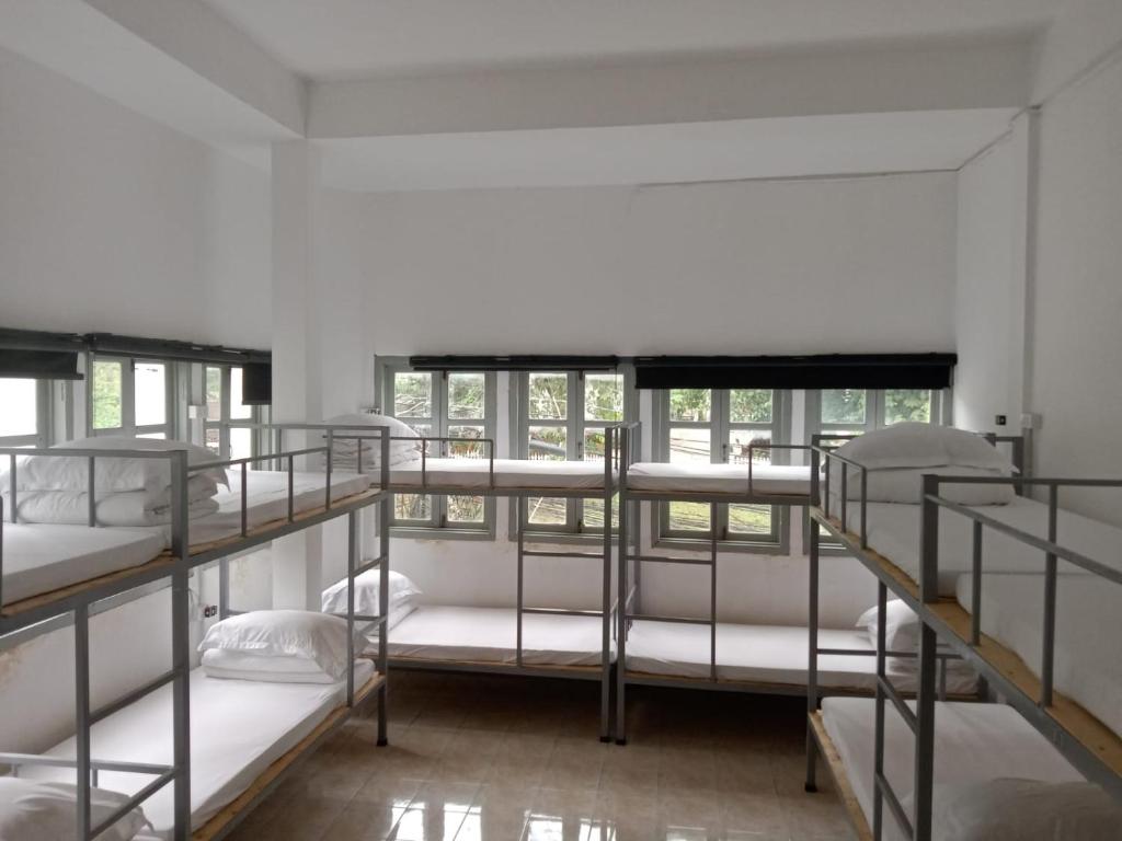a room with four bunk beds in a building at MK Hostel in Luang Prabang