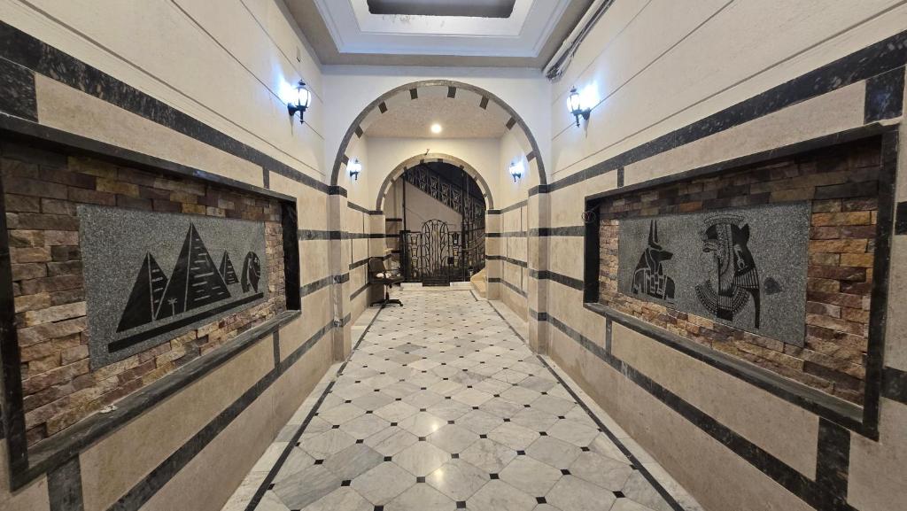 a hallway with paintings on the walls of a building at Cairo Nomads Hostel in Cairo