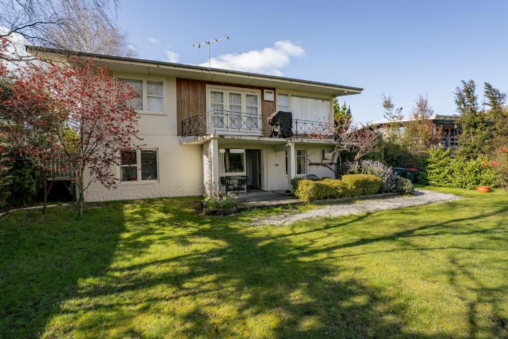 a house with a large yard in front of it at Wanaka Central Holiday Escape in Wanaka
