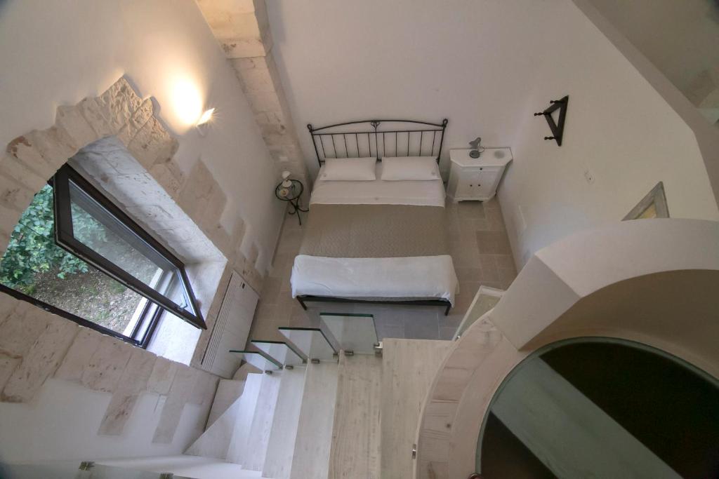 ロコロトンドにあるCasa Nonna Linaのベッド付きの部屋、窓のある階段
