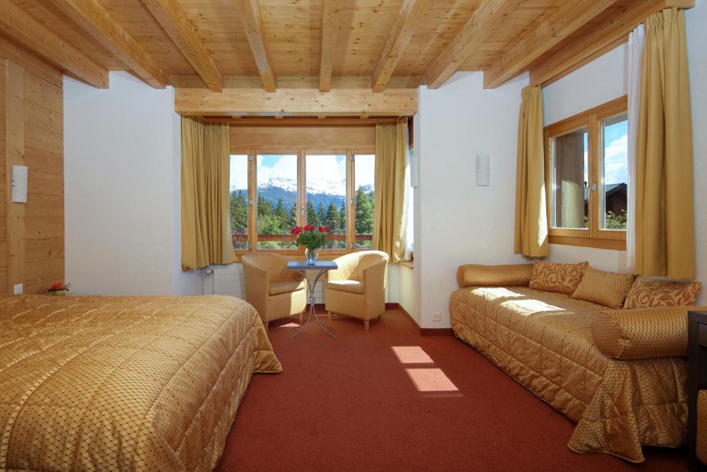 Postel nebo postele na pokoji v ubytování Hotel La Prairie