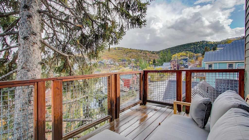 a balcony with a couch and a tree at Quittin Time Townhouse Peaceful Mountain Ski-In-Ski-Out Retreat Close to Town in Park City