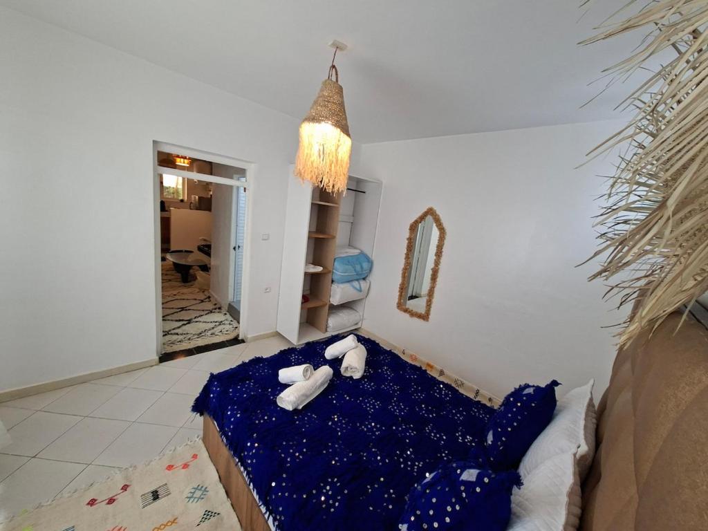 a room with a bed with two stuffed animals on it at Essaouira Stay with private Terrace in Essaouira
