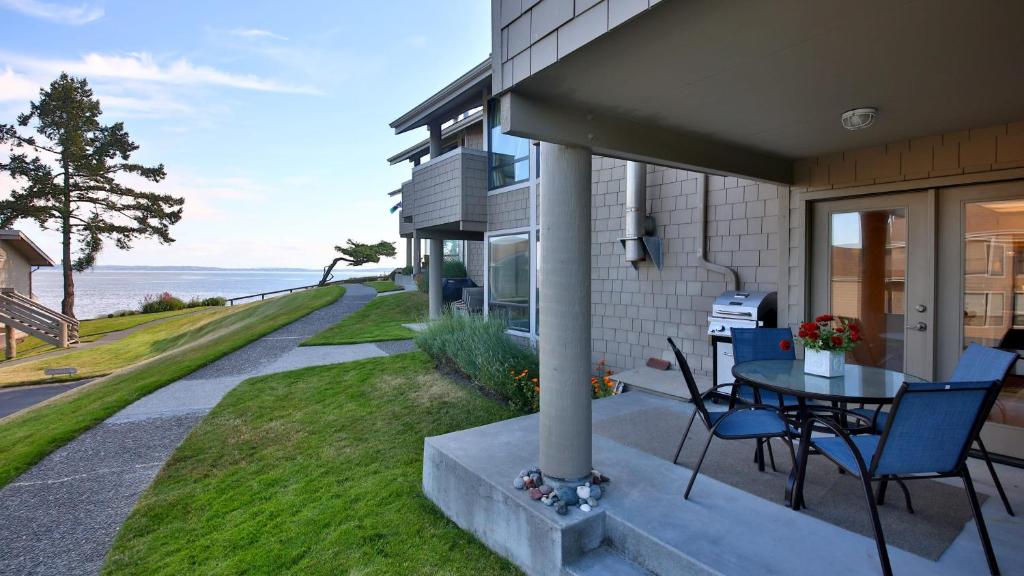 a patio with a table and chairs on a house at Beachfront Condo - Mutiny Bay by AvantStay Views in Freeland