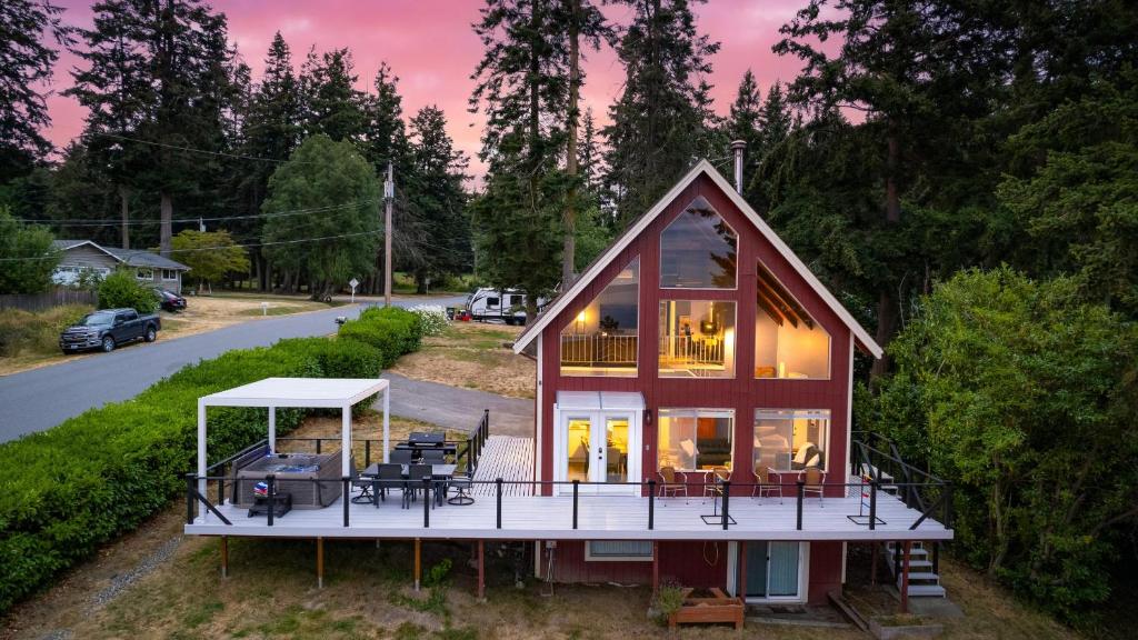 a small house with a porch and a deck at Polnell Point Lookout by AvantStay Water Views Hot Tub Large Patio in Oak Harbor