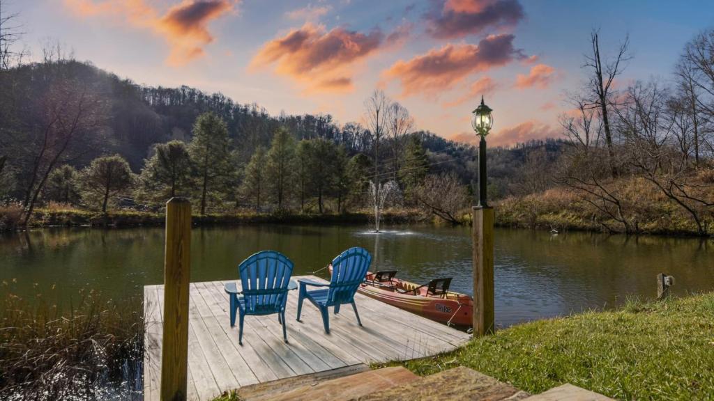 two chairs and a light on a dock next to a boat at Hamersmith Hollow Retreat by AvantStay Mountain Views in Mars Hill