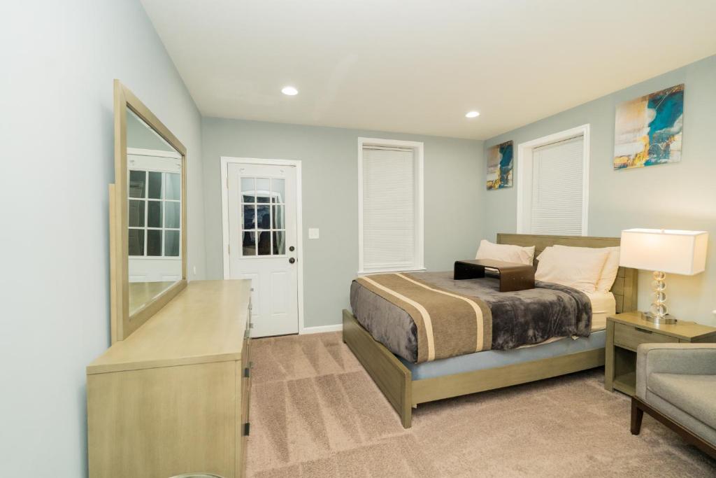 a bedroom with a bed and a mirror at Downtown upper canton 3 bdrm 3 bath home with rooftop and parking pad in Baltimore