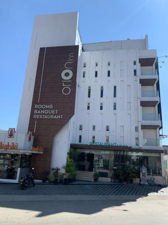 a building with a sign that reads ozone banquet restaurant at Hotel Orion Inn in Tirupati